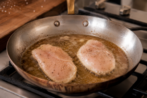 Transfer the chicken to a plate and cover it with foil. Let it rest before making the Alfredo sauce.