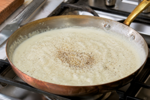 Transfer the chicken to a plate and cover it with foil. Let it rest before making the Alfredo sauce.